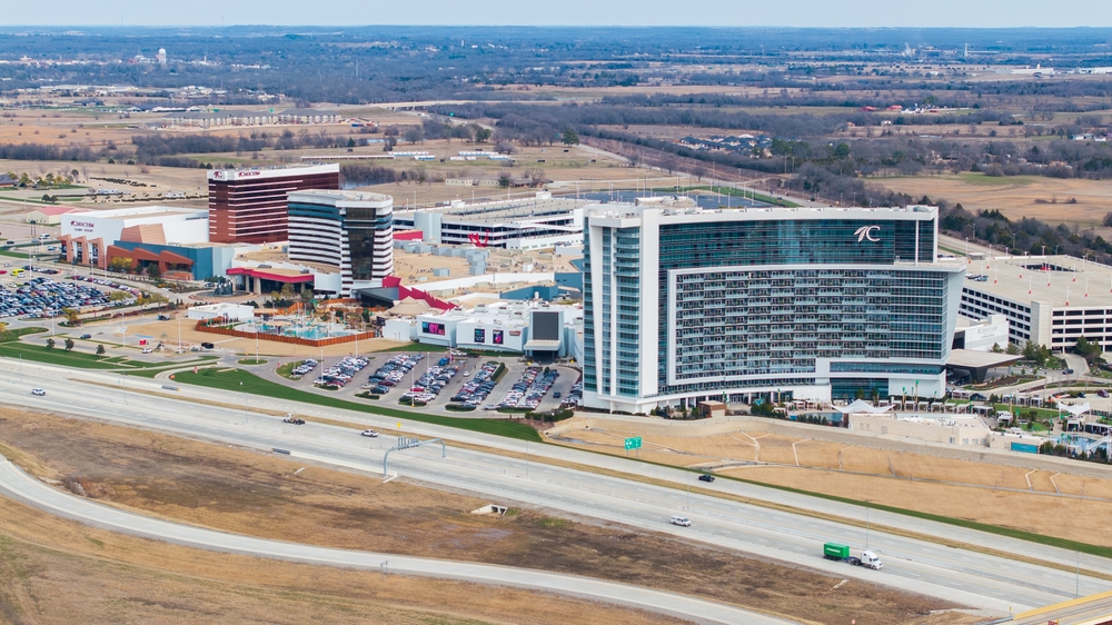 Daytime wide exterior of Choctaw Casino Resort in Durant Oklahoma—massive entrance and parking under blue sky