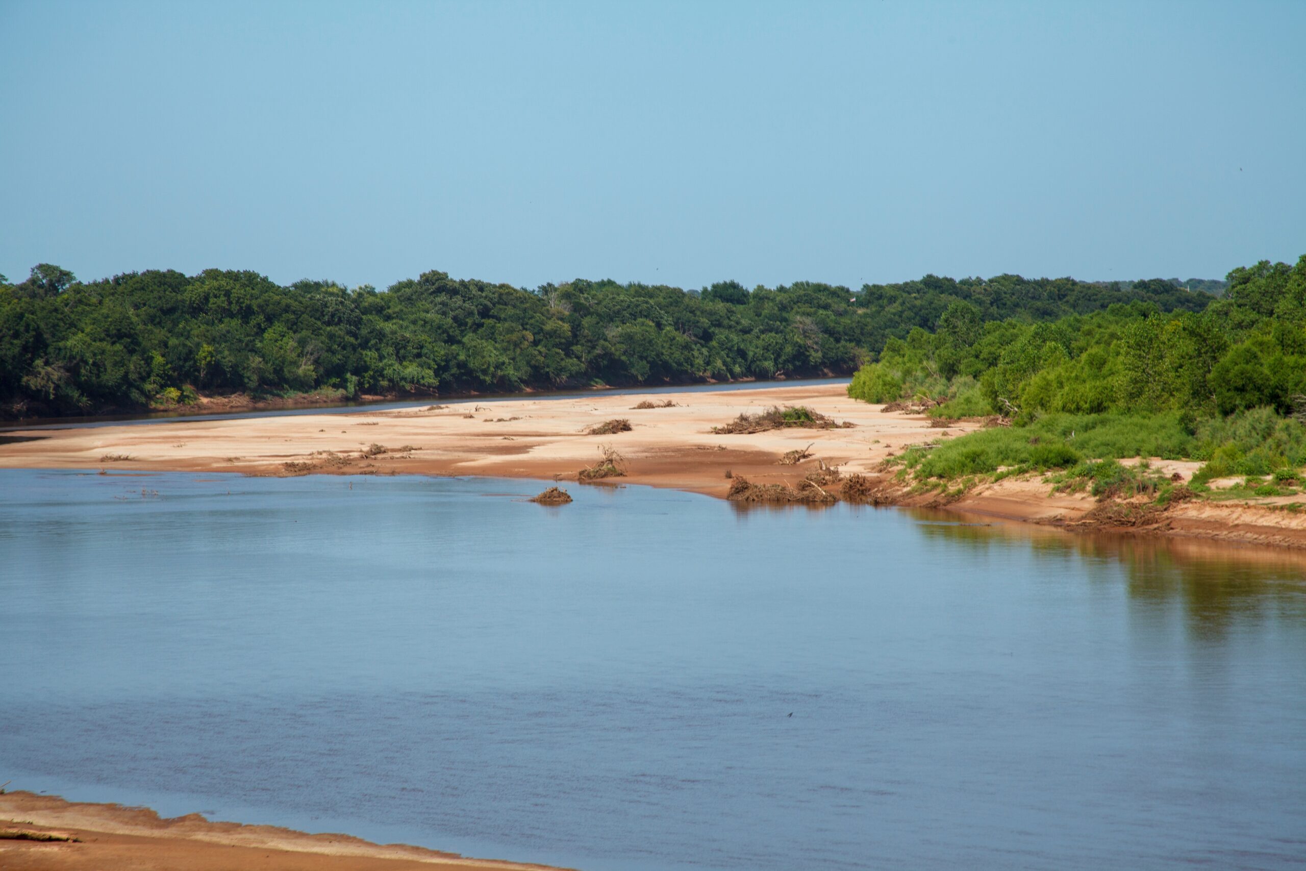 Red River border between Bells Texas and Durant Oklahoma—sandy shores and calm waters at sunset